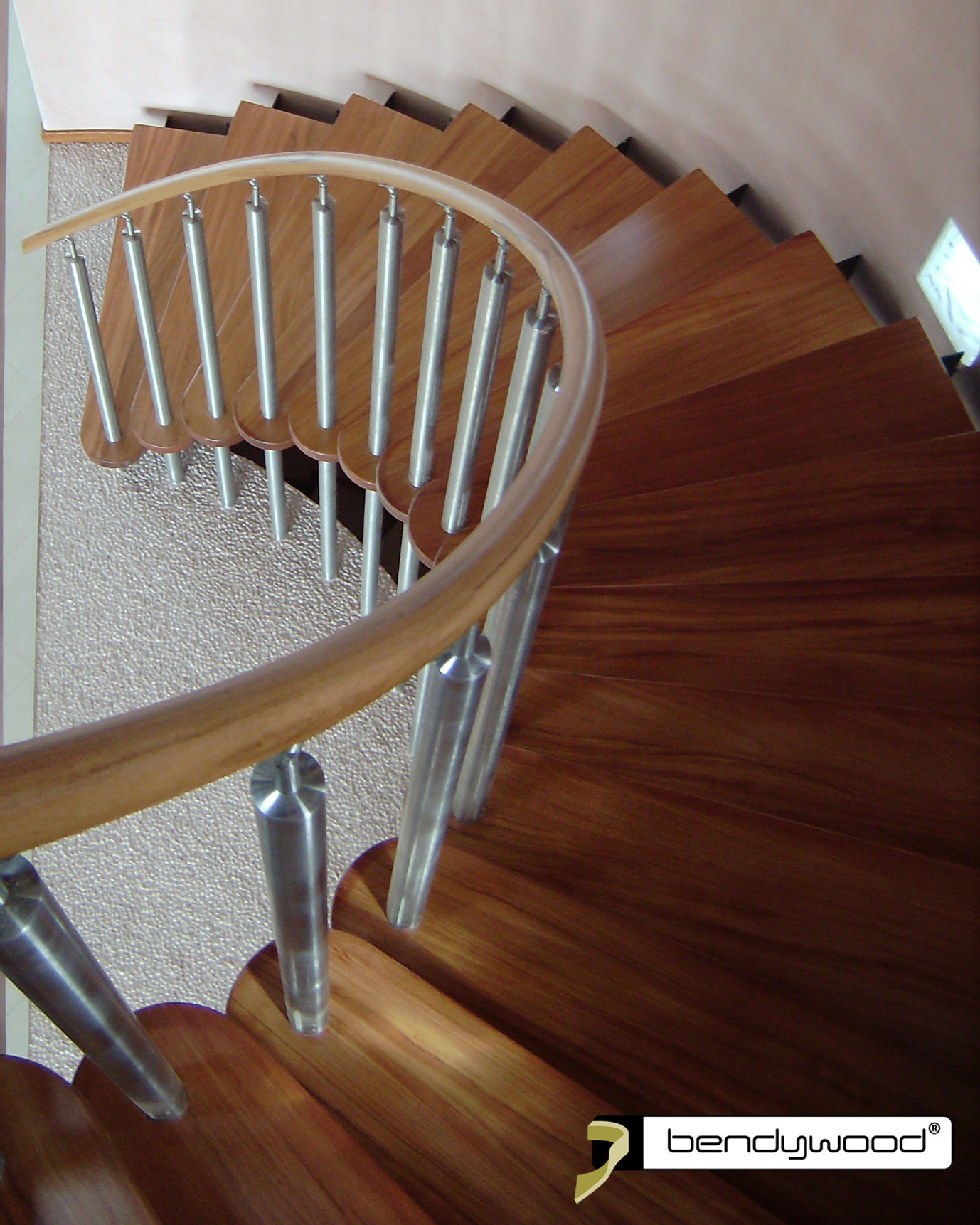 Round bending handrail in Bendywood®-doussié for curved staircase.